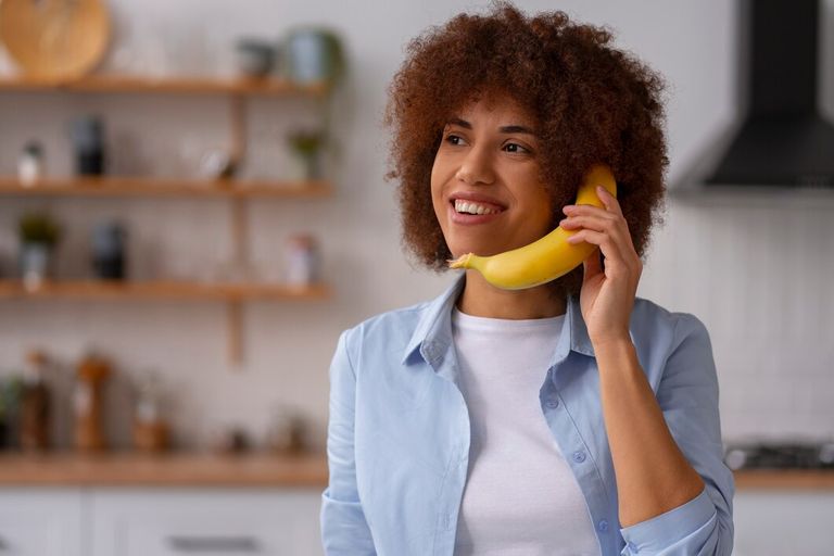 front-view-woman-holding-banana_23-2150241094.jpg