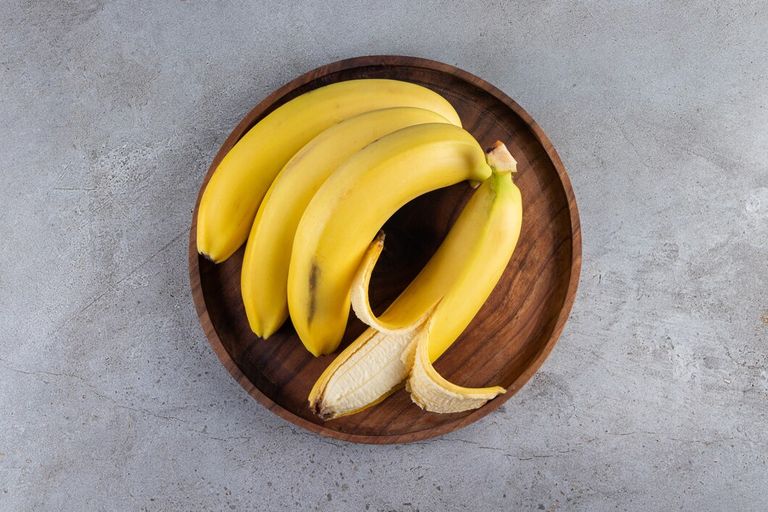 bunch-juicy-yellow-banana-placed-stone-table_114579-46666.jpg