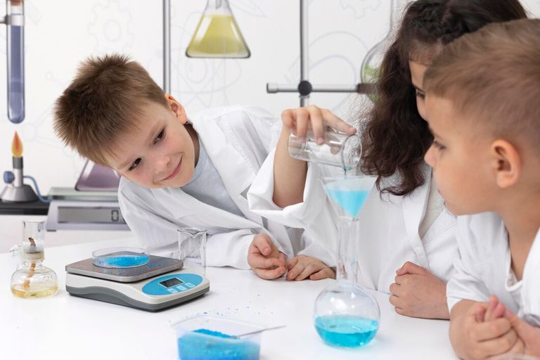 colleagues-doing-chemical-experiment-school_23-2148990190.jpg