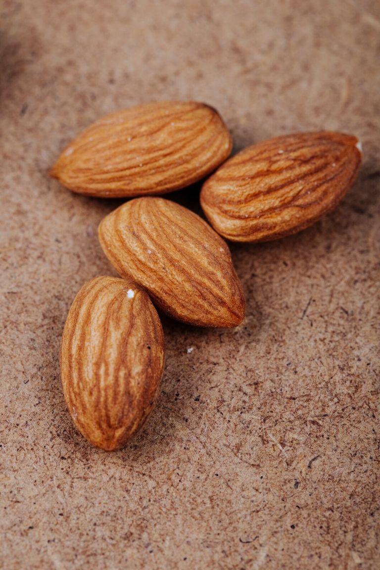 top-view-almond-nuts-old-paper-texture-background_141793-8890.jpg