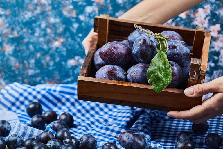 hand-holdong-wooden-basket-garden-plums-blue_114579-62154.jpg