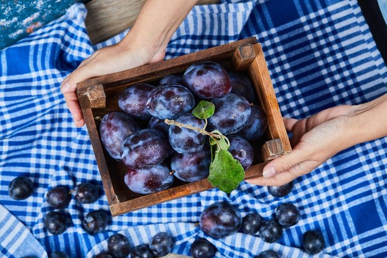 hand-holding-wooden-basket-garden-plums-wooden-table-high-quality-photo_114579-53018.jpg