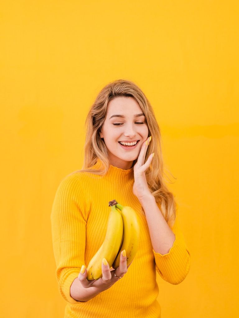 smiley-female-holding-bananas_23-2148487123.jpg