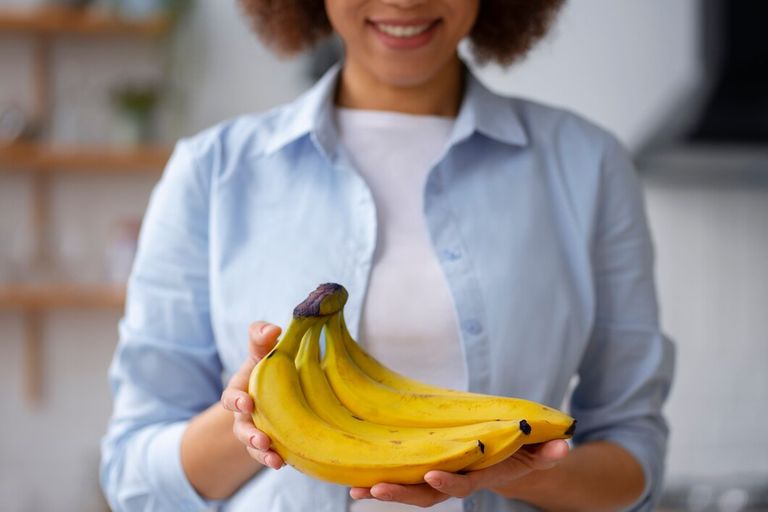 front-view-woman-holding-bananas_23-2150241088.jpg