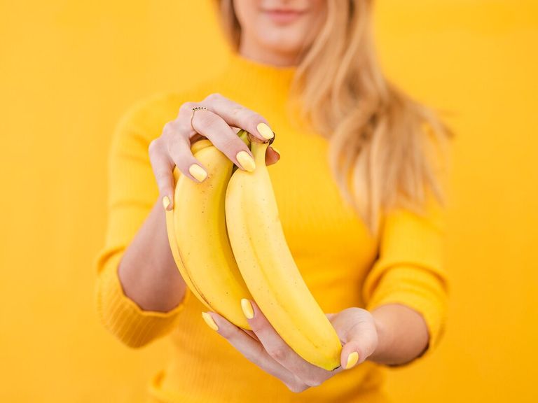 close-up-woman-with-bananas_23-2148487124.jpg