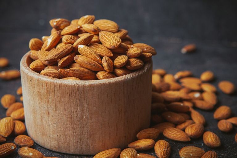 peeled-almonds-wooden-bowl-dark-table_176474-5495.jpg