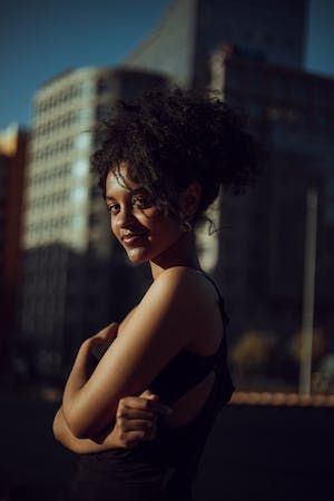 free-photo-of-smiling-black-woman-posing-in-city-downtown.jpeg