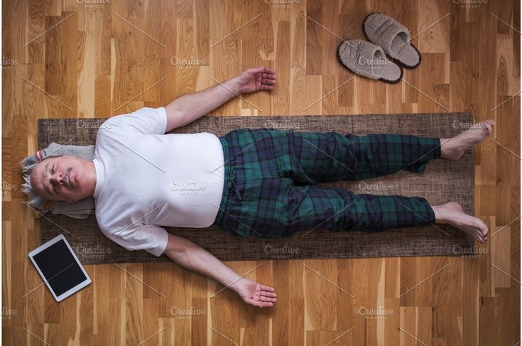 Senior man meditating on a wooden.jpeg