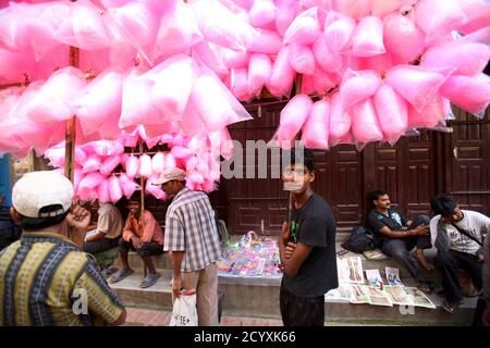 a-street-vendor-selling-cotton-candy-waits-for-customers-during-the-krishna-janmashtami-festival-in-lalitpur-near-kathmandu-august-21-2011-krishna-janmashtami-a-festival-marking-the-birth-of-hindu-god-krishna-is-.jpg