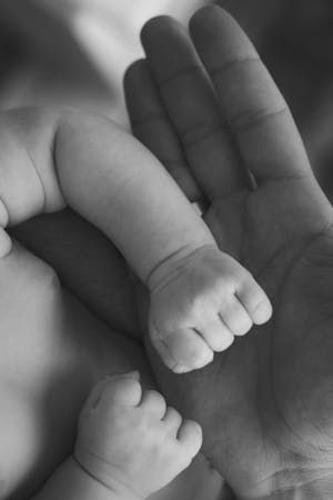 free-photo-of-close-up-of-hand-of-a-man-holding-arm-of-a-newborn-baby.jpeg