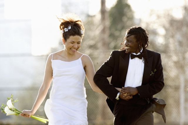 bride-and-groom-walking-hand-in-hand-high-res-stock-photography-1579817740.jpg