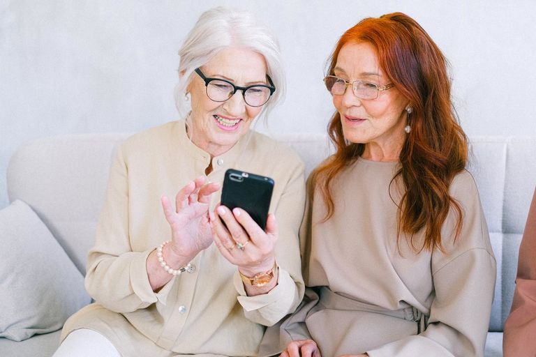 cheerful senior women chatting online 